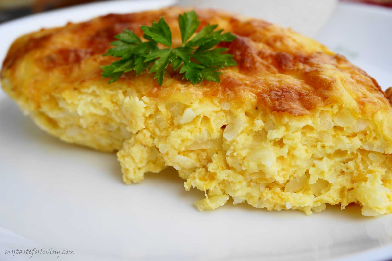 Appetizing casserole prepared with eggs, potatoes, cheddar, cheese, yellow cheese and cream cheese.