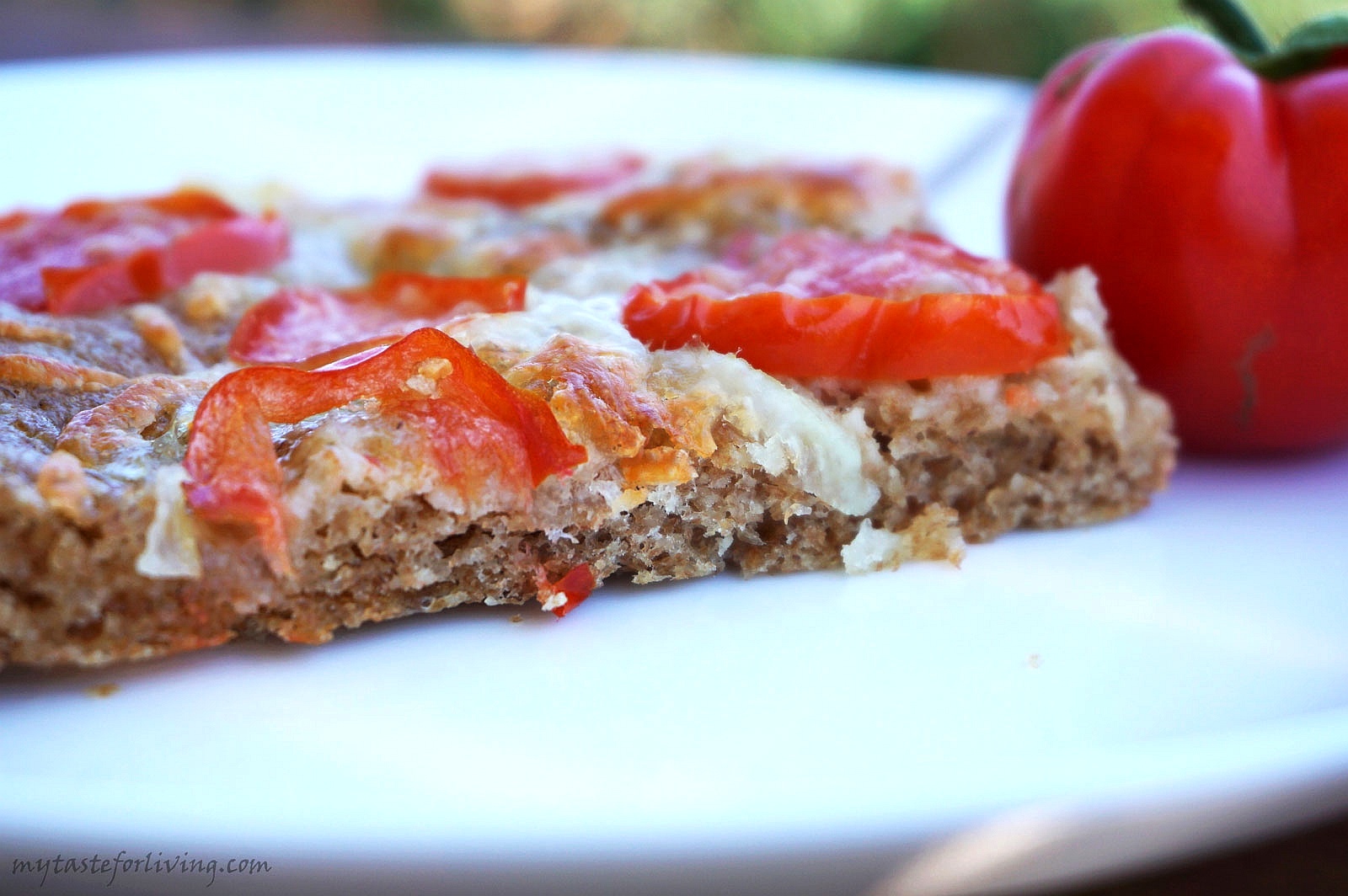 Easy and delicious whole wheat focaccia with tomatoes, mozzarella and parmesan.
