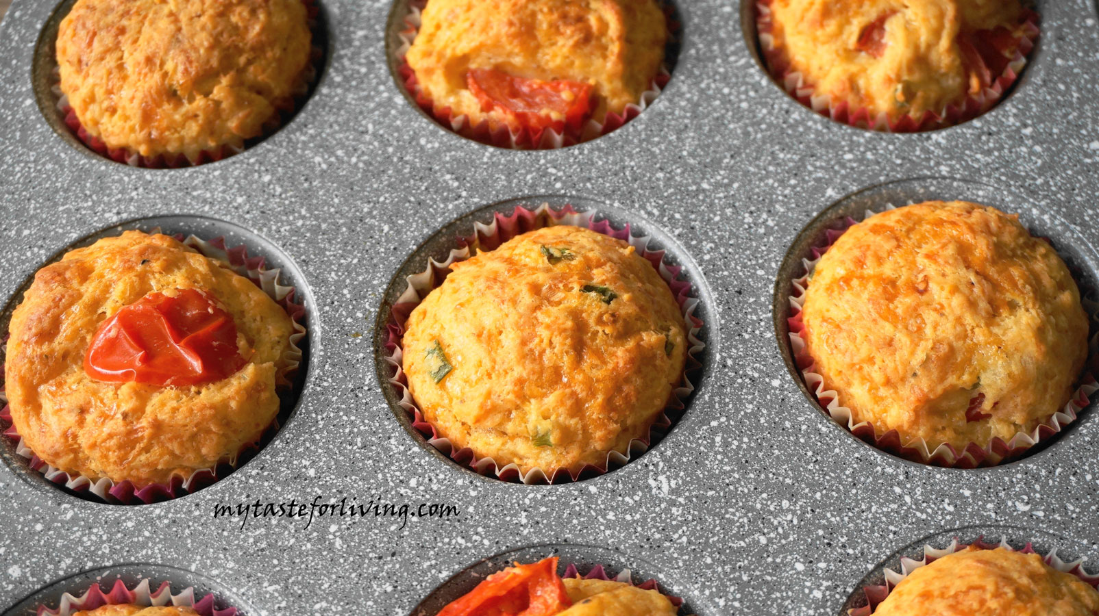 Salted muffins with cherry tomatoes, cheddar, fresh green onions and oregano, reminding us of the taste of pizza.